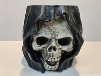 Front view hooded skull container