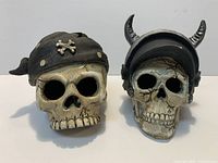 Front view of both skull decorations side by side