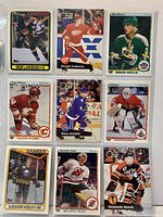 Front view of all nine hockey rookie cards in protective sleeves