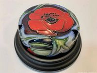 Top view of Moorcroft paperweight showing poppy design and glazing