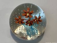 Top view showing orange flowers, blue stems and air bubbles