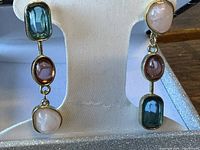 Front view of earrings on stand showing stone colours and arrangement