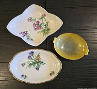 Top view of three decorative porcelain dishes showing patterns and colors