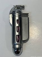 Full view of silver butane torch lighter on white background