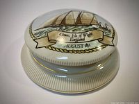 oblique view showing ship decal, gold trim and ribbed base