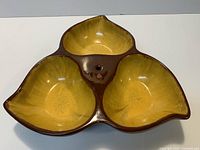 top view showing three yellow compartments with brown rim