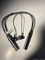 Full view of HTC neckband earbuds laid flat