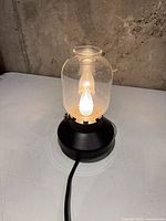 Lamp illuminated showing glow through clear glass shade