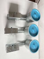 Three Liteline recessed light housings with blue covers and junction boxes
