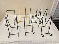 Eight metal easels arranged on table