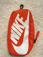 Front view showing orange pouch and white Nike logo