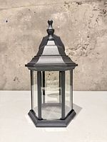 Front view of black metal and glass outdoor wall lantern