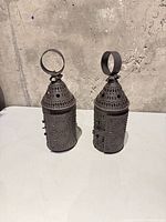 Front view showing both pierced metal lanterns with hanging loops