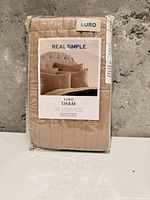Front of sealed package showing Real Simple euro sham label and color
