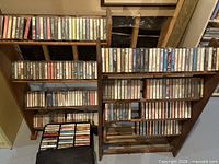 Two wood cassette racks filled with tapes
