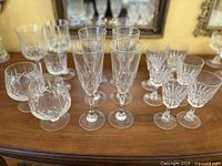 Group view of assorted cut crystal stemware on wooden surface