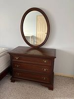 Full view of dresser with attached oval mirror