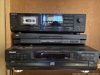 Stacked Sony cassette deck, JVC DVD player, Philips CD changer front view