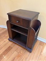 Front view showing drawer, open shelf, magazine rack