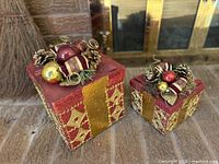 Two decorative boxes with lids closed showing exterior design