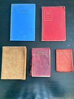 Five books laid out showing cover colours and titles