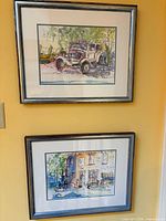 Both framed paintings displayed vertically on wall