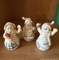 Group shot of three snowman figurines