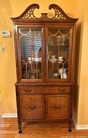 Full view of china cabinet showing glass doors, drawer and lower cabinet