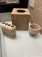 Three stone bathroom accessories on counter