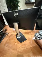 Rear view of Dell monitor showing brand logo, stand and ports