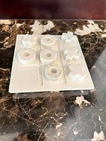 Top view of marble board with playing pieces arranged