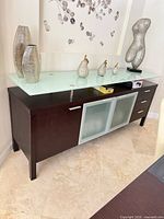 Front view showing entire buffet with glass top and storage layout