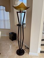 Full view of floor lamp showing base, frame and shade