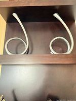 Both chrome spiral sculptures on shelf