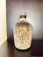 Front view of distressed ceramic vase showing overall form and finish