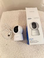 Camera, USB cable, and box laid out on surface