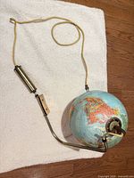 Full view of globe lamp with arm, counterweight and cord