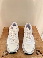 Top view of both sneakers showing lace-up fronts, slight stain on left toe