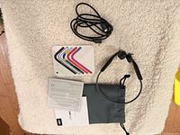 All items laid out: headphones, USB-C cable, sticker guide, paperwork, pouch