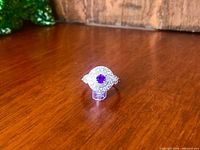 Ring front view showing amethyst and CZ halo
