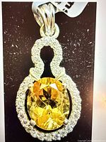 Front view of pendant showing citrine and halo