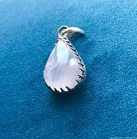 Front view of teardrop rose quartz pendant in silver bezel