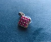 Front view of silver pendant showing ruby cluster