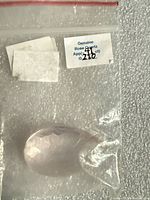 Front view of faceted pear gemstone in zip bag