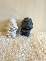 front view of both Stormtrooper figurines showing color difference and size