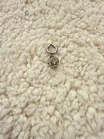 Front view of sterling silver geometric cage charm with jump ring