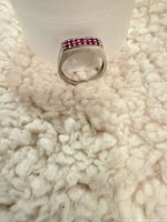 Angle view of sterling silver ring showing bar-top rubies