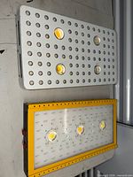 Front view of both LED grow lights showing housings, COB emitters and diode arrays