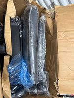 Box opened showing plastic-wrapped chair components