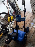 Full view of Snow Joe iON18SB-HYB snow blower showing handle, wheels, chute